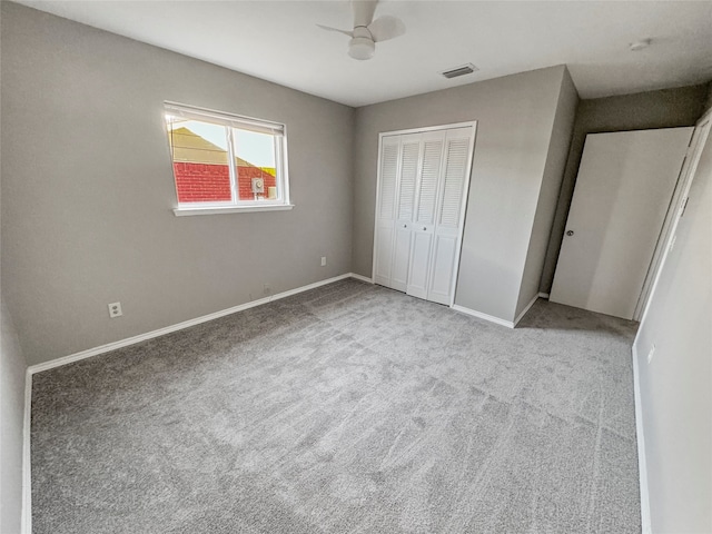 unfurnished bedroom with light carpet, a closet, and ceiling fan