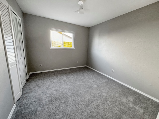 unfurnished bedroom featuring a closet and dark carpet