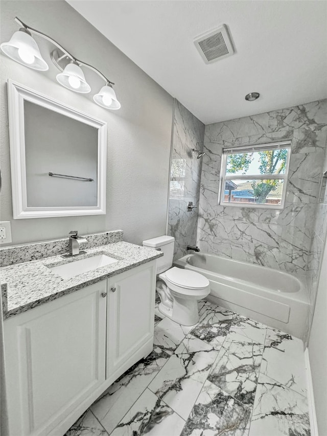 full bathroom with tiled shower / bath combo, vanity, and toilet