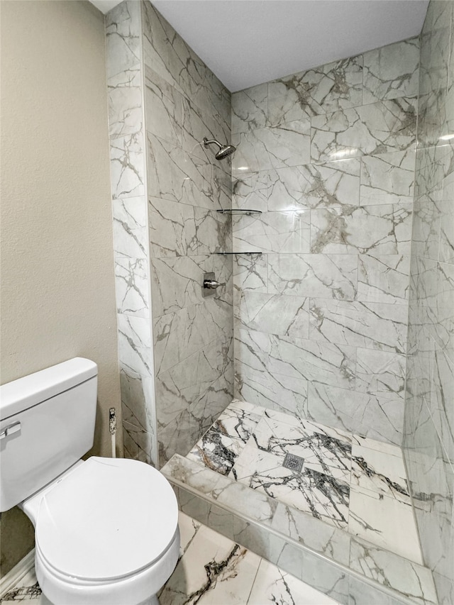 bathroom featuring toilet and tiled shower