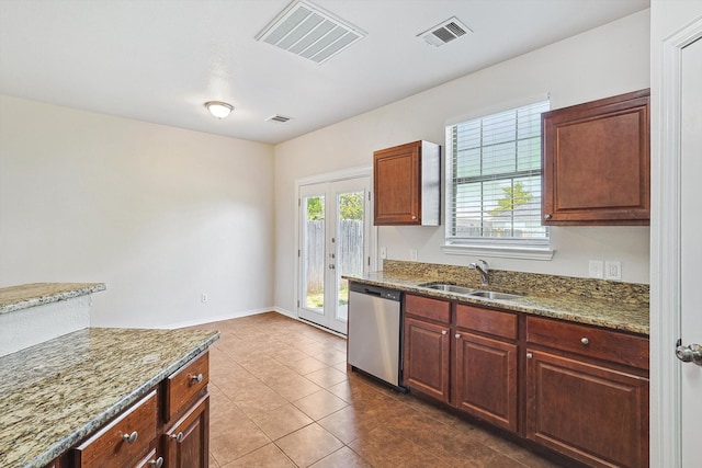 kitchen featuring light stone counters, tile patterned floors, sink, and stainless steel dishwasher