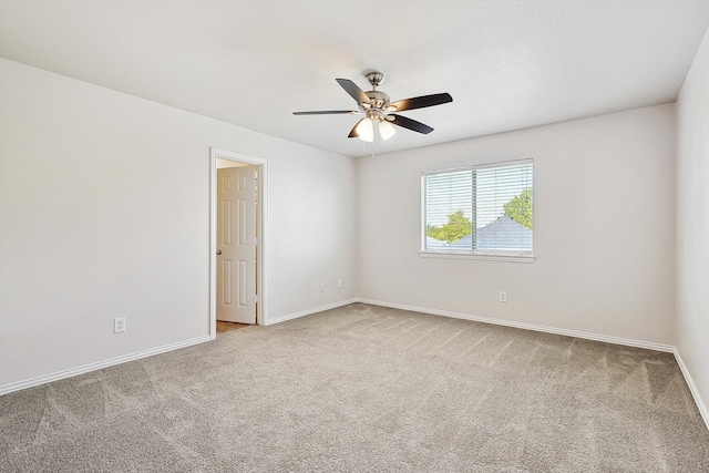 carpeted empty room featuring ceiling fan