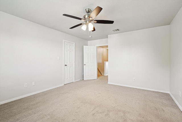 carpeted spare room featuring ceiling fan