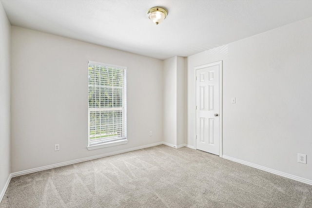 carpeted spare room with a healthy amount of sunlight