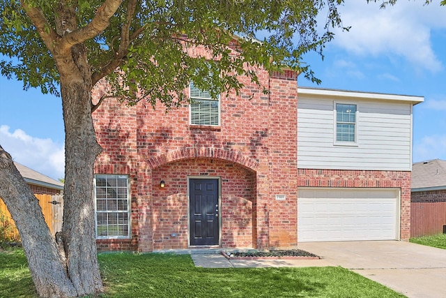 view of front of property featuring a garage and a front yard