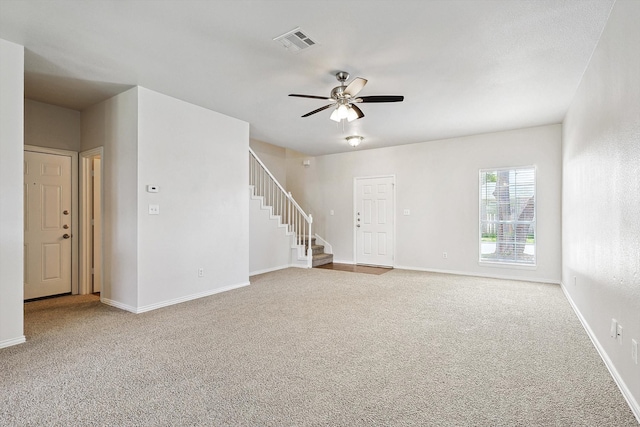 empty room with ceiling fan and carpet