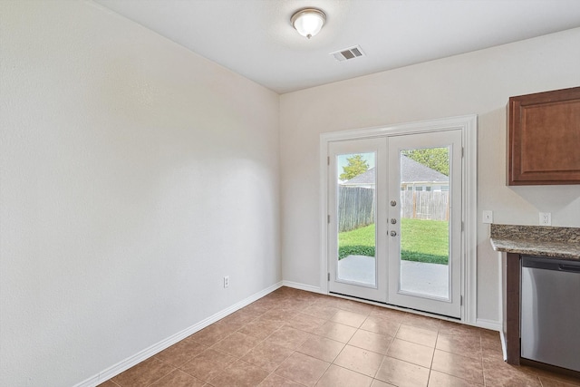 entryway with french doors and light tile patterned flooring