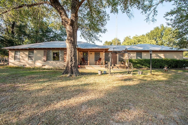 back of property with a yard and a patio