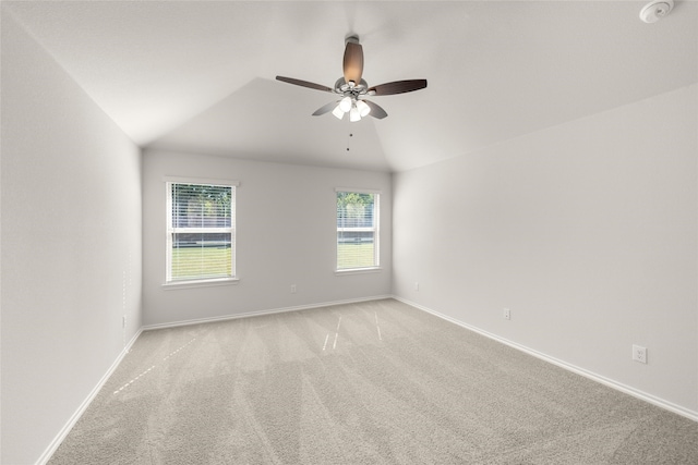 carpeted empty room with ceiling fan and vaulted ceiling