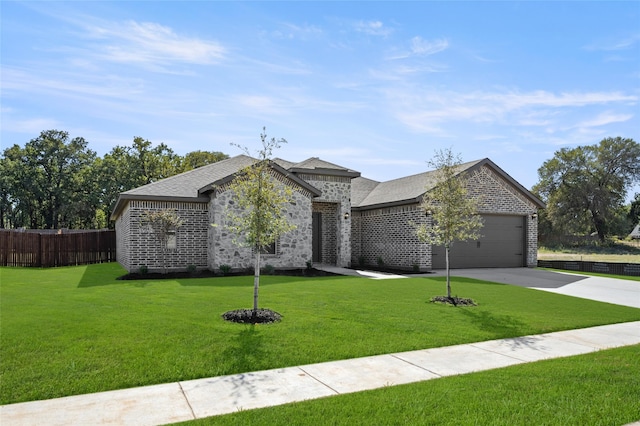 view of front of property featuring a front yard and a garage