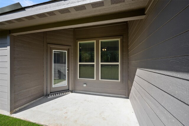 entrance to property featuring a patio