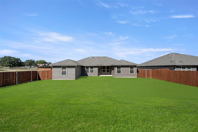 back of house featuring a patio area and a yard