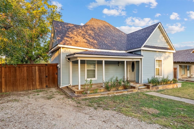 view of front of property with a front yard and covered porch