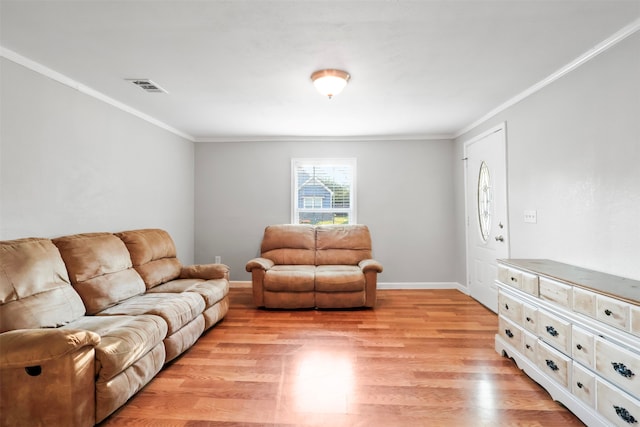 living room featuring ornamental molding and light hardwood / wood-style flooring