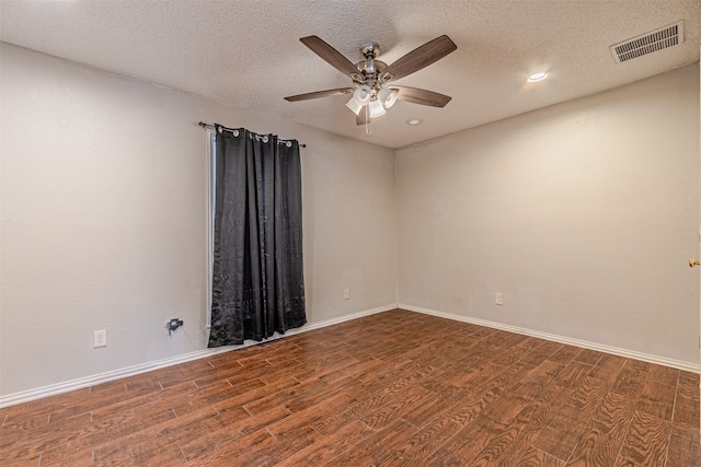 unfurnished room with ceiling fan, dark wood-type flooring, and a textured ceiling