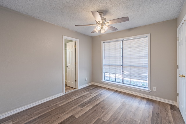 unfurnished room featuring hardwood / wood-style flooring, ceiling fan, and a textured ceiling