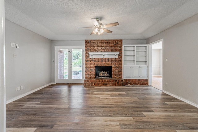 unfurnished living room featuring dark wood-type flooring, a fireplace, and a textured ceiling