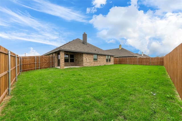 rear view of house featuring a yard