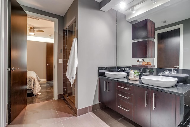 bathroom with ceiling fan, vanity, tile patterned flooring, and a shower with door