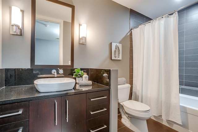 full bathroom featuring vanity, shower / bath combo with shower curtain, toilet, and tile patterned floors