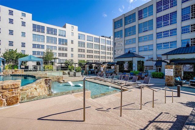 view of pool featuring a gazebo, a patio, and pool water feature