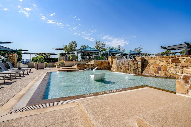 view of swimming pool featuring a patio and pool water feature