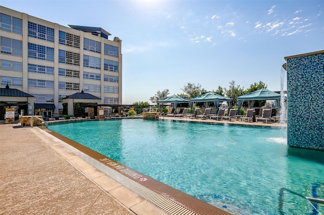 view of pool with a gazebo, a patio area, and pool water feature