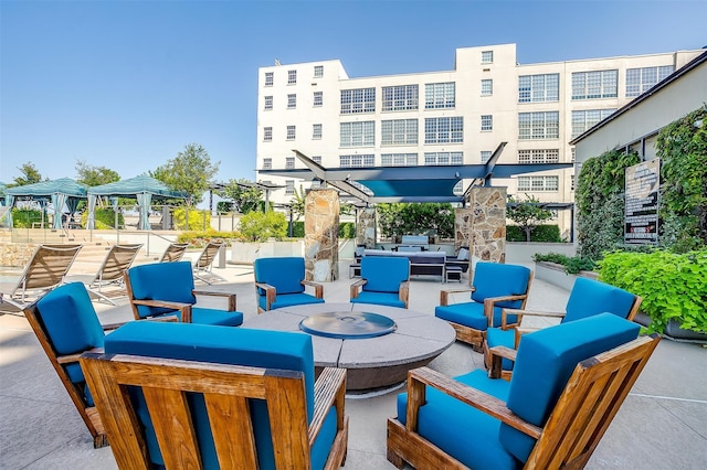 view of patio / terrace with an outdoor living space with a fire pit