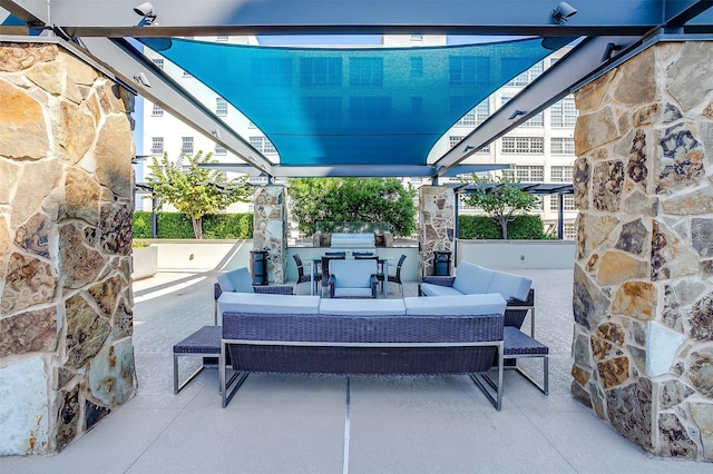 view of patio with exterior kitchen, outdoor lounge area, and grilling area