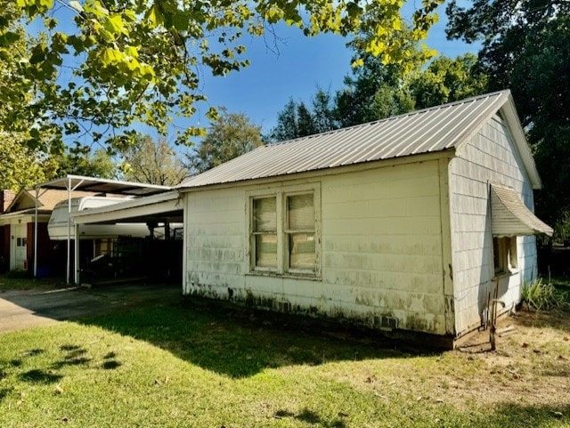 view of property exterior with a carport and a lawn