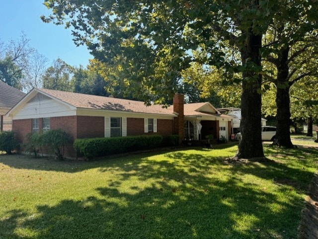 ranch-style home with a front lawn