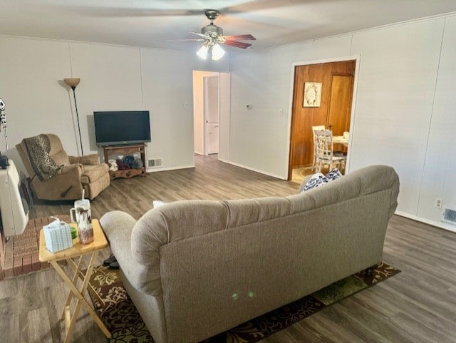 living room featuring ceiling fan and wood-type flooring