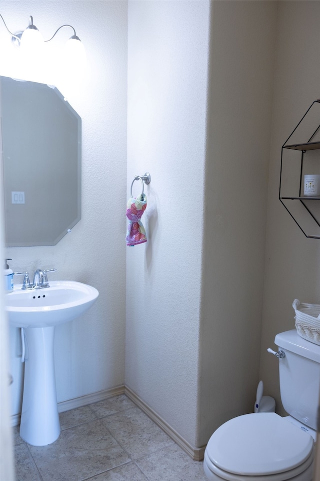 bathroom featuring tile patterned floors and toilet