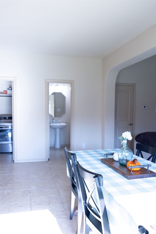 dining room with sink and light tile patterned floors