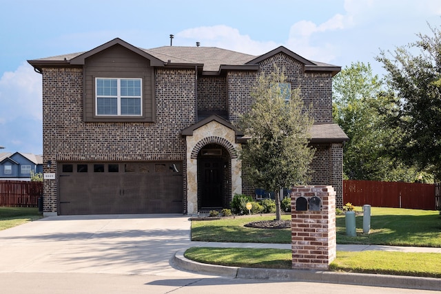 view of front of property featuring a garage and a front yard