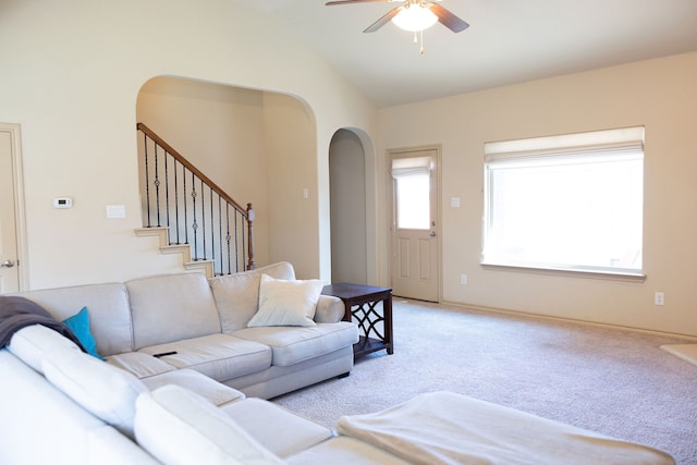 living room featuring light carpet, lofted ceiling, and ceiling fan