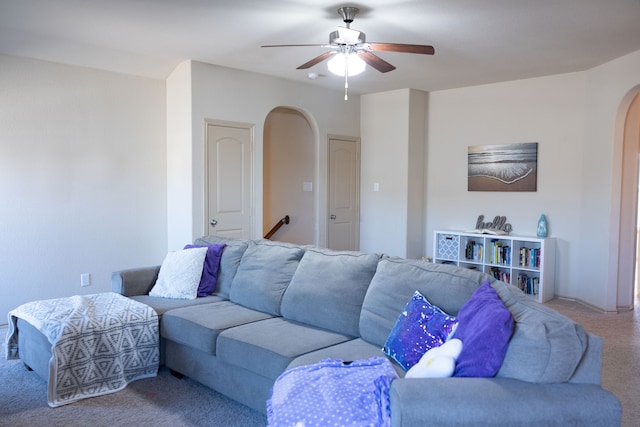 living room with ceiling fan and light colored carpet