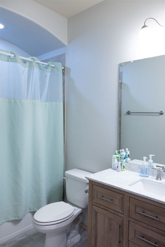 full bathroom with vanity, toilet, and shower / tub combo with curtain