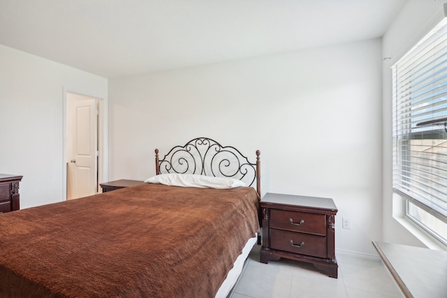 bedroom featuring light tile patterned floors and multiple windows