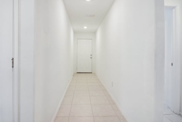 corridor featuring light tile patterned floors