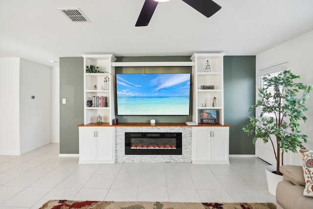 living room featuring light tile patterned flooring and ceiling fan