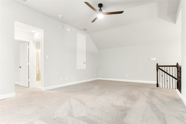 additional living space featuring ceiling fan, vaulted ceiling, and light carpet