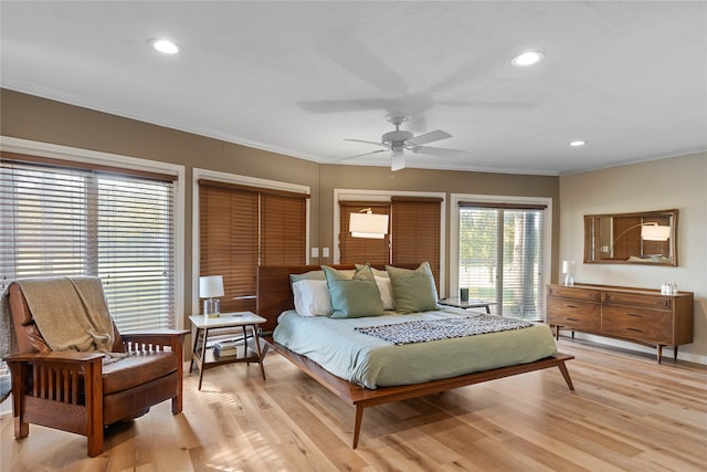 bedroom featuring ornamental molding, light hardwood / wood-style flooring, and ceiling fan