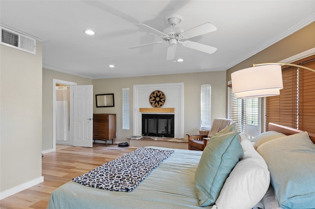 bedroom with ceiling fan, ornamental molding, and light hardwood / wood-style floors