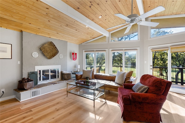 living room with wooden ceiling, plenty of natural light, beamed ceiling, and light wood-type flooring