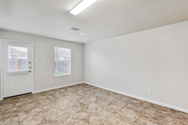 spare room featuring a textured ceiling