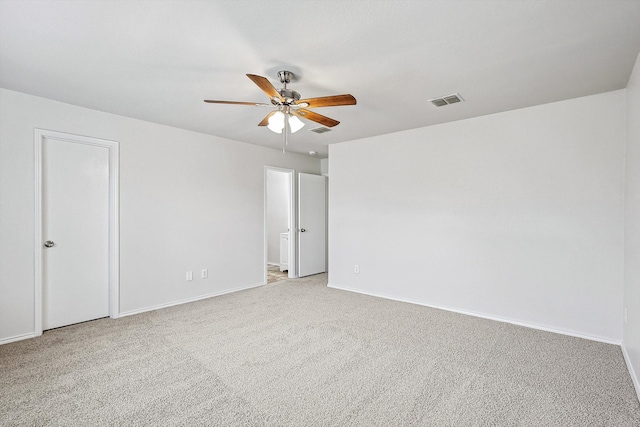 carpeted empty room featuring ceiling fan