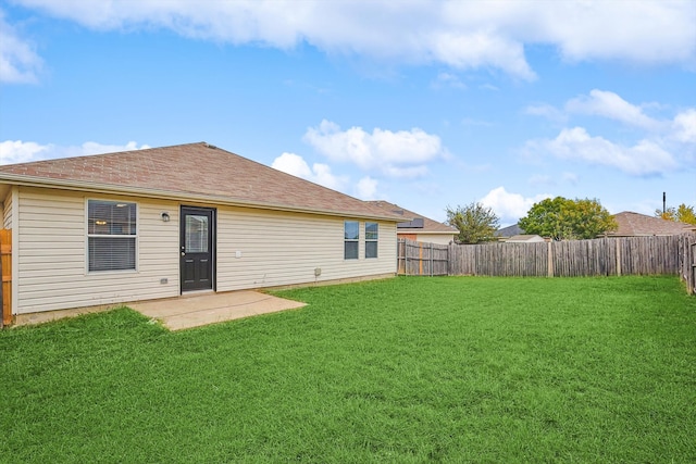 rear view of house featuring a patio and a lawn