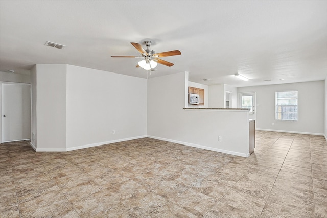 unfurnished room featuring ceiling fan