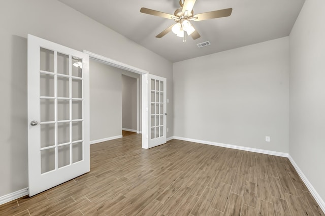 spare room with ceiling fan and french doors